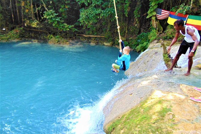 Rope swing  in the cascading waterfalls at Blue Hole Secrets Falls Ocho  Rios