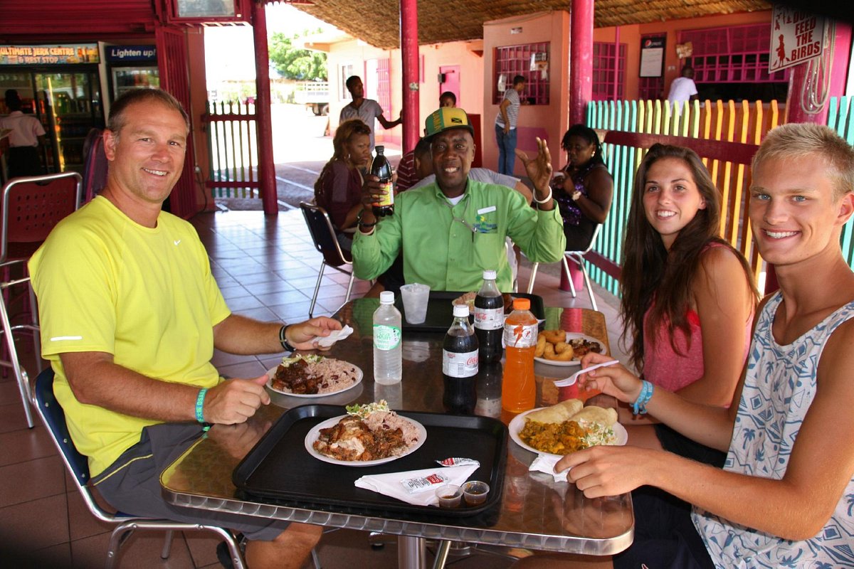  Guests enjoying spicy jerk chicken at a Montego Bay eatery