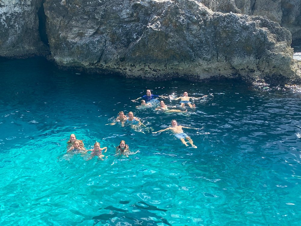 Swimmers enjoying the turquoise waters at Rick's Cafe, Negril.