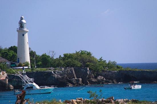 Negril Lighthouse standing tall against a clear blue sky.