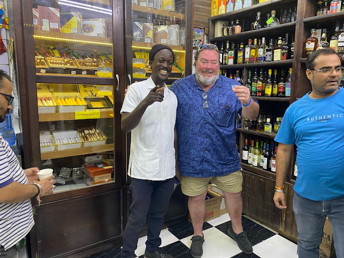 Tourists browsing a liquor store with Jamaican spirits