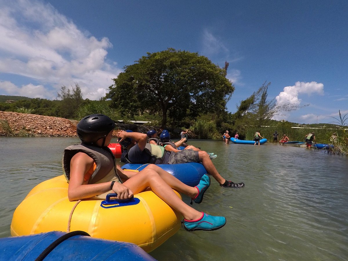 Adventurers navigating rapids on a jungle river tubing experience