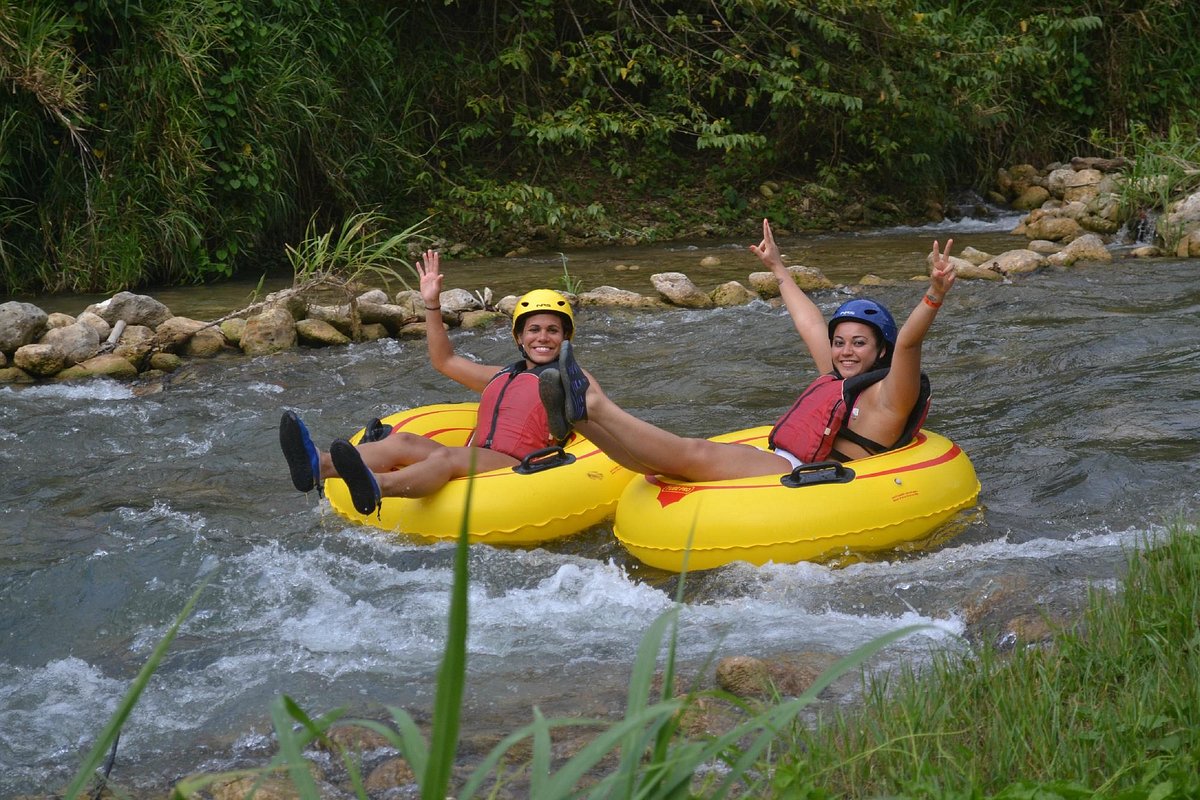 Adventurers navigating rapids on a jungle river tubing experience