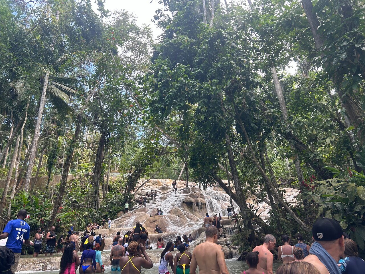Cruise passengers climbing Dunn’s River Falls during a guided shore excursion from Falmouth cruise port in Jamaica