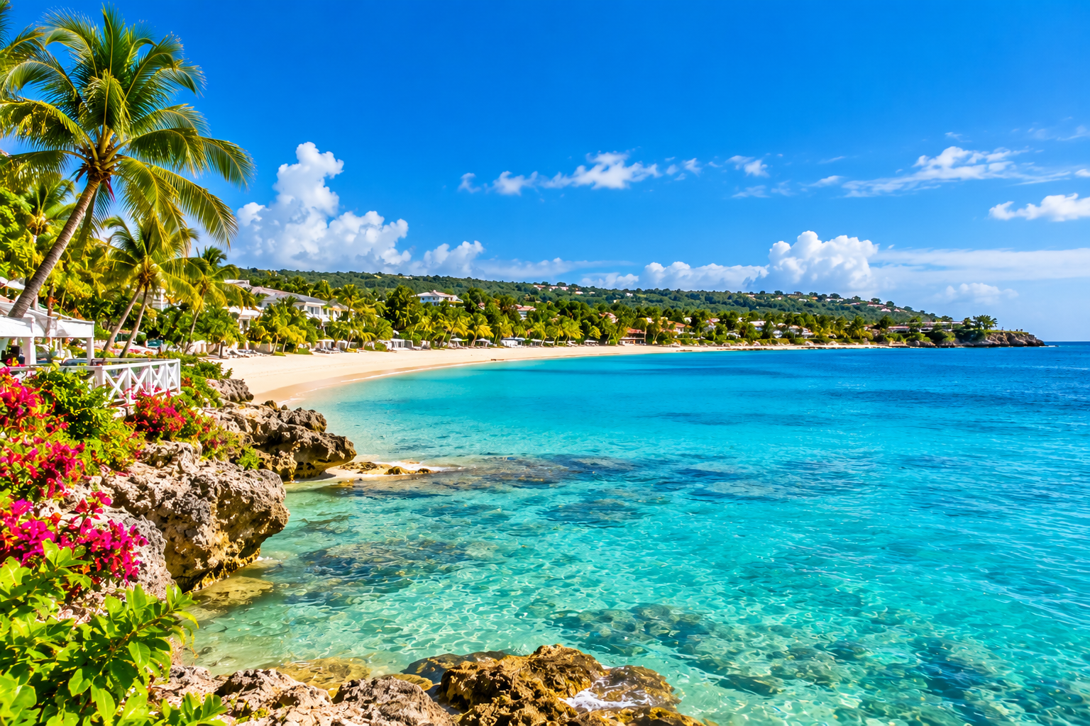 Runaway Bay Jamaica tropical beach with clear turquoise water, palm trees and beachfront resorts